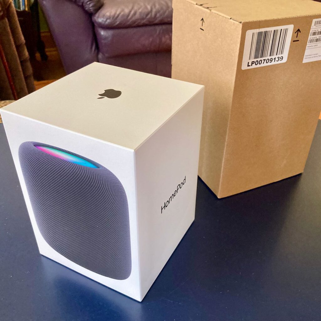 a HomePod box in the foreground and a packaging box in the background