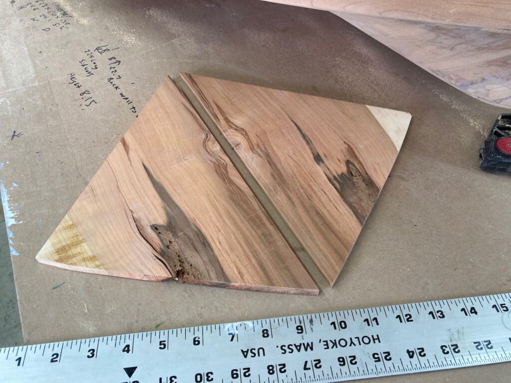 A carefully selected piece of cherry wood was cut to create a bookmatched section for inlay into the bow.