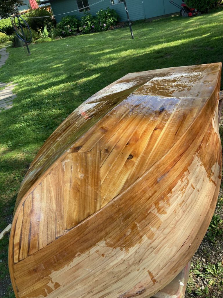 Wooden boat under construction. Fiberglass and epoxy on the bottom of the hull.