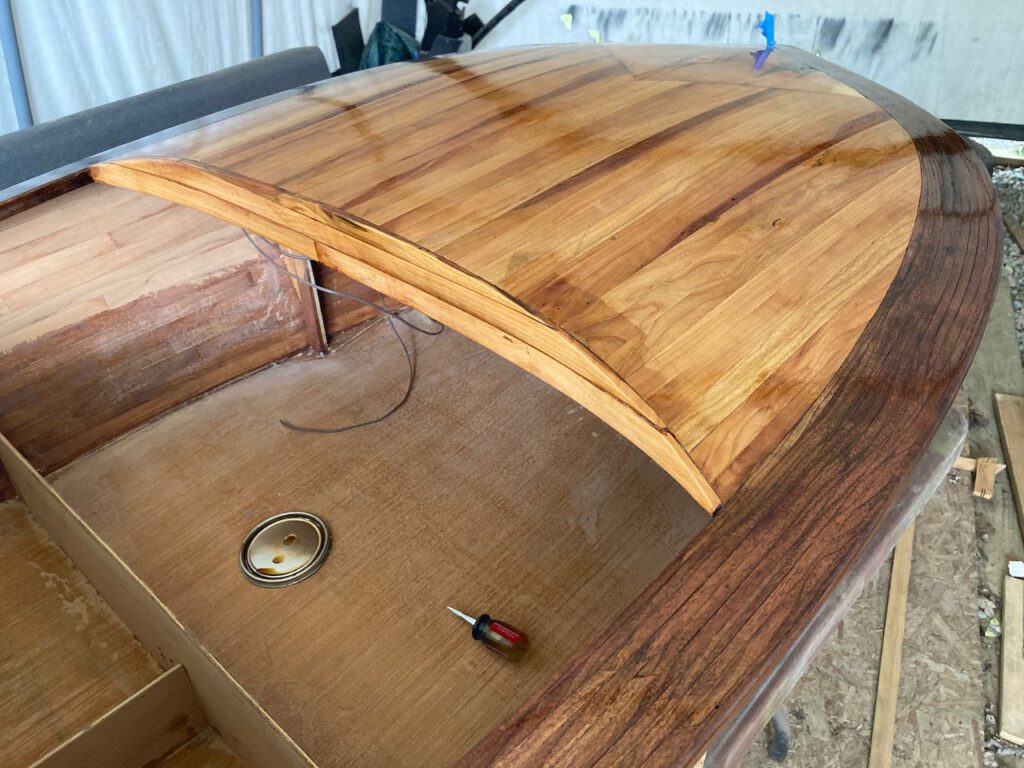 First coat of varnish on the foredeck of this small boat.