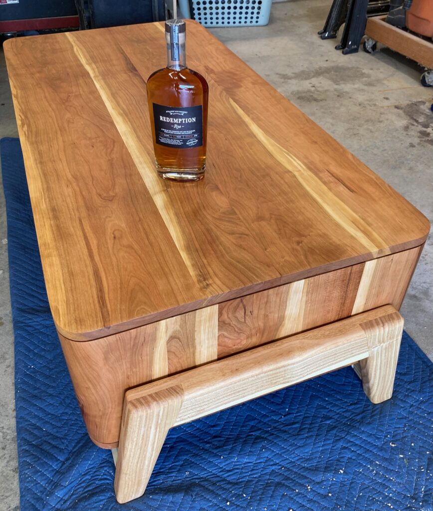 view of the table from above, with a whiskey bottle placed in its center.